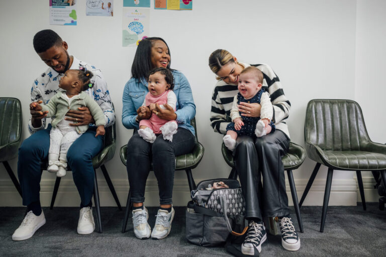 Foster parents with babies in a waiting room